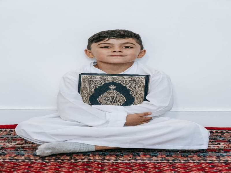 Student reading the Holy Quran during an online class session